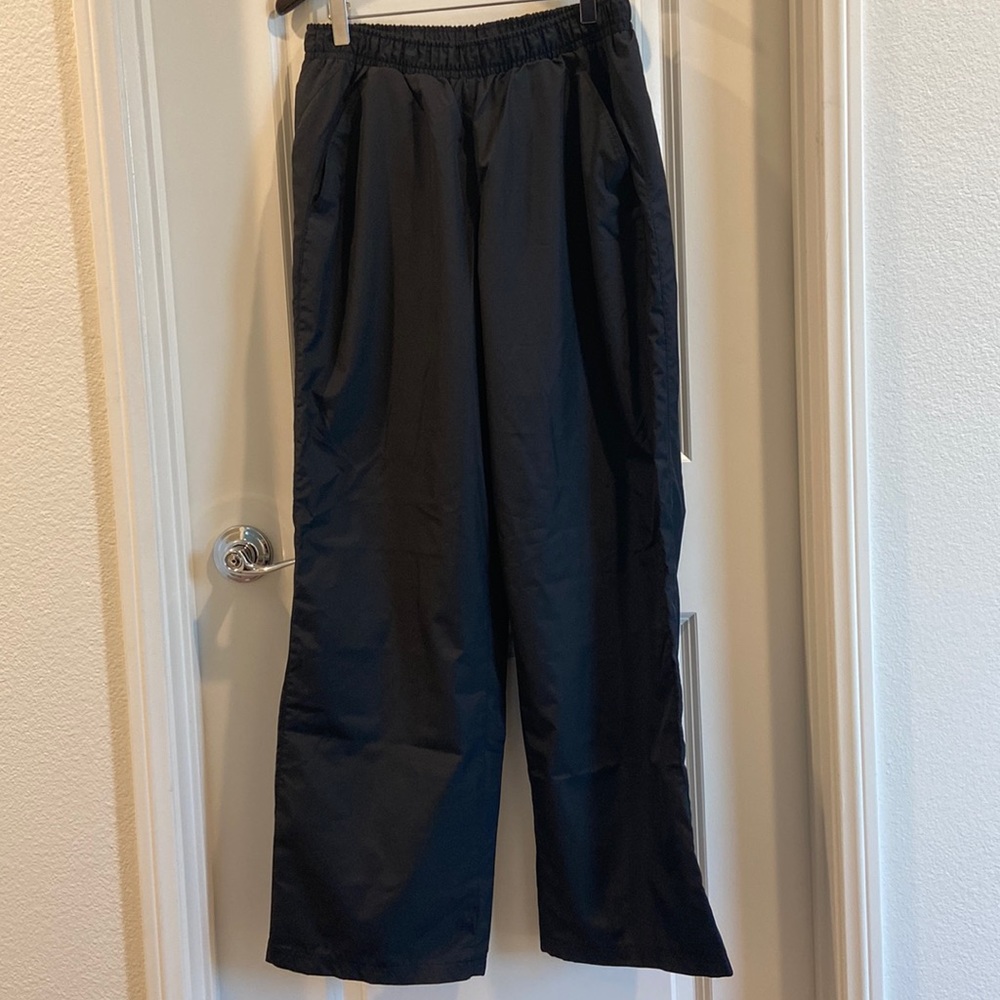 Champion black pants with zipper opening at ankles.